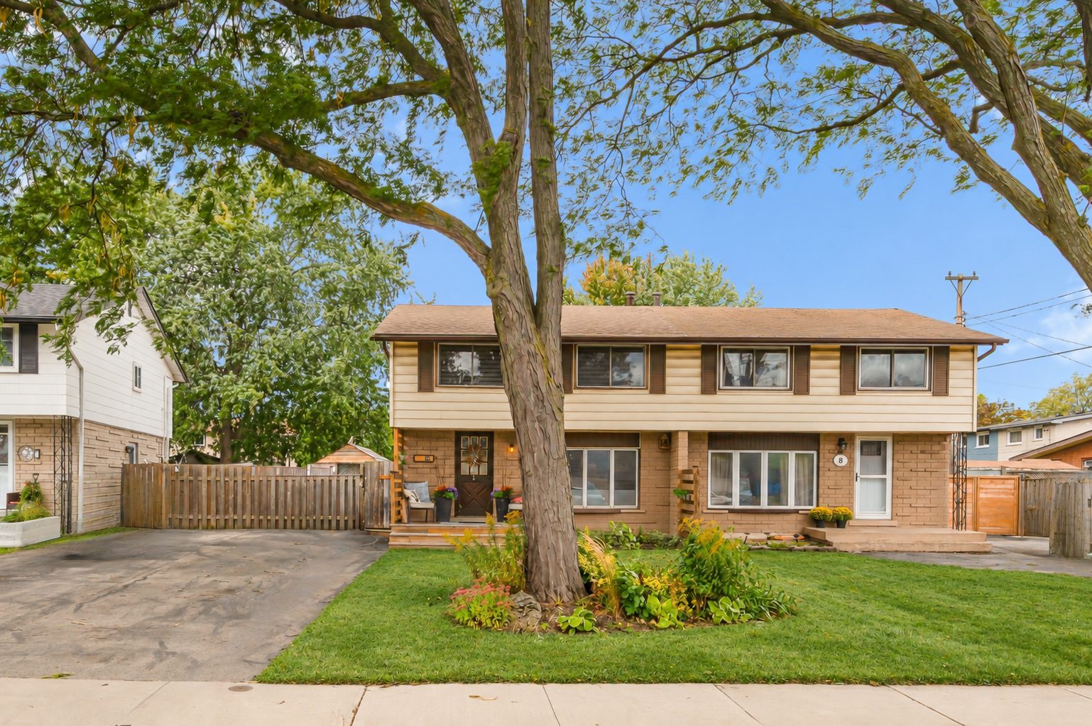 Front of 10 Goldfinch Road, a two-storey brick semi with a mature tree on the front lawn